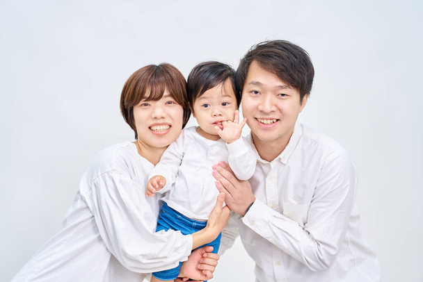 Family smiling and lining up in front of white background - Photo, Image
