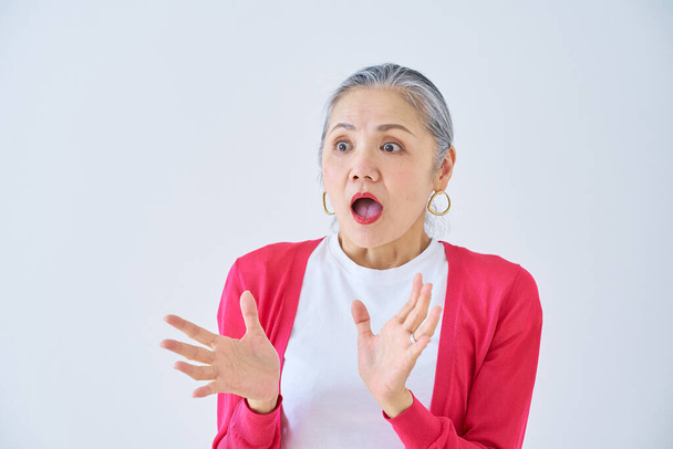 Senior woman with a surprised expression indoors - Photo, Image