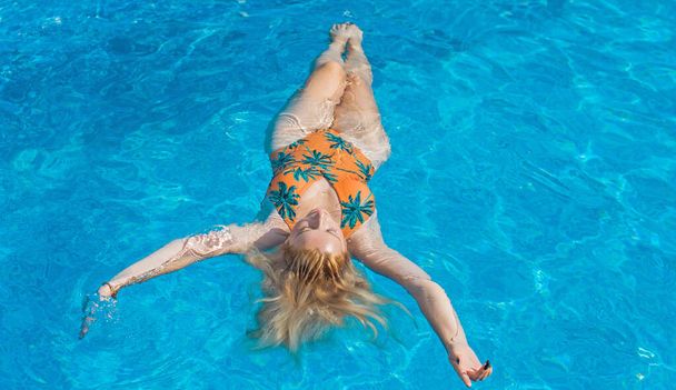 Плюс размер женщины в бассейне, наслаждайтесь жизнью, пляжная одежда, купальник, солнечный. Стиль L- размер, счастливая красивая натуральная красавица - Фото, изображение