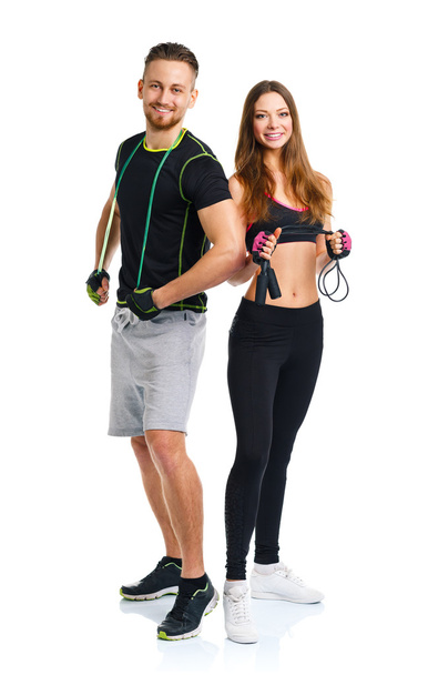Happy athletic couple - man and woman with with ropes on the whi - Foto, Imagem