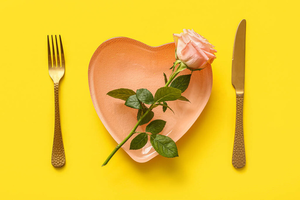 Gyönyörű asztal beállítás rózsával Valentin-napra sárga alapon - Fotó, kép