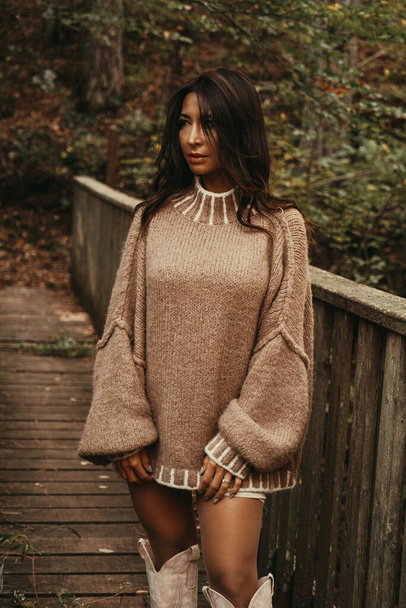 A fashionable woman donning a trendy poncho outdoor                                - Photo, Image