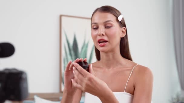 Young woman making beauty and cosmetic tutorial video content for social media. Beauty blogger smiles to camera while showing how to beauty care to audience or followers. Adit - Footage, Video