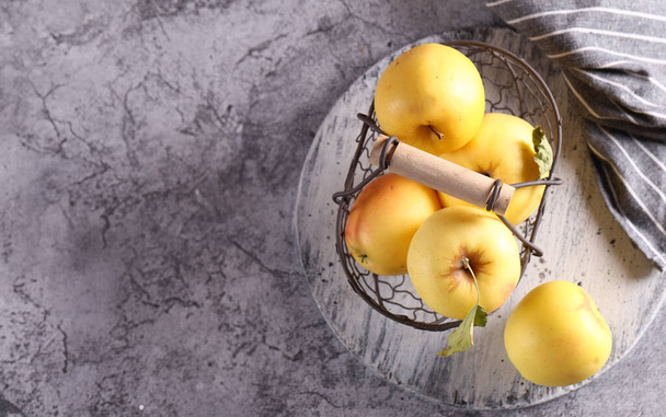 Gelbe Bio-Äpfel im Korb auf dem Tisch - Foto, Bild