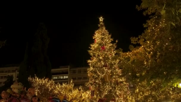 Різдвяна ялинка та вогні вночі в оздобленій та освітленій центральній площі Синтагма в Афінах, Греція. фон зимових свят. - Кадри, відео