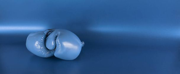 blue boxing gloves on a blue background - Photo, Image
