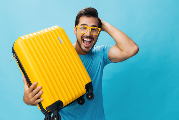Αποσκευές εισιτηρίων άντρας ταξίδι αντίγραφο ταξίδι περιοδεία διακοπές πτήση hipster ευτυχισμένο κίτρινο στυλ μπλε ταξίδι στούντιο ταξίδι αποσκευές χώρο φόντο βαλίτσα lifestyle ταξιδιώτη διακοπές Σαββατοκύριακο - Φωτογραφία, εικόνα