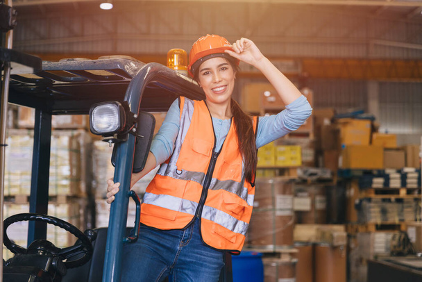 Happy asian female young worker works in port cargo shipping logistic transport industry enjoy smiling working operate forklift driver. - Photo, Image