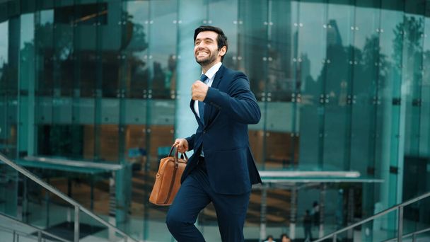 Successful business man celebrate for getting promotion while walking to office. Caucasian receive good news about sales increase or successful project. Manager feel overjoy and happy. Exultant. - Photo, Image