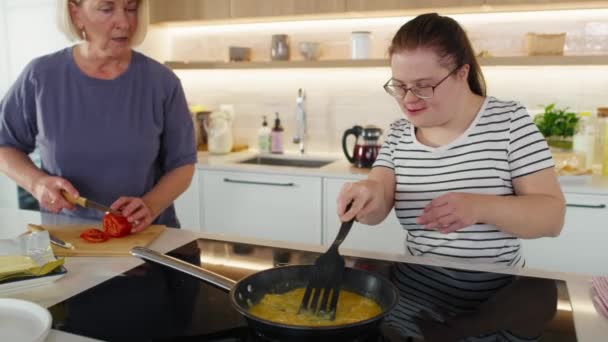 Down syndrome woman and her mother preparing breakfast together. Shot with RED helium camera in 8K.    - Footage, Video