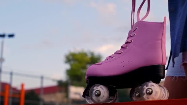close-up hand taking roller skates in a skate park, outdoor training, ice skating, extreme sport - Footage, Video