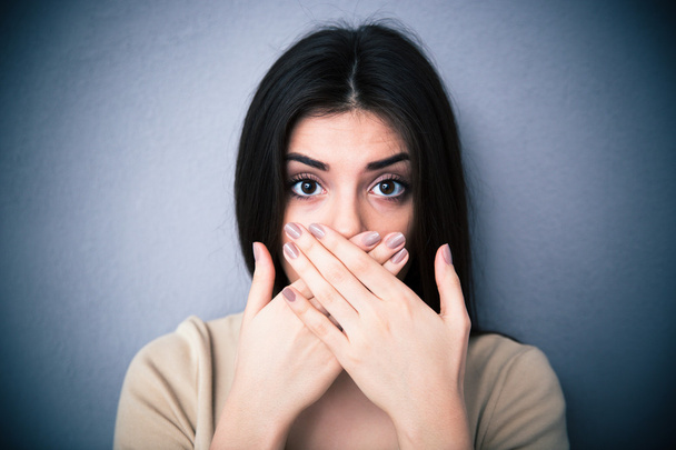 Portrait of a young woman covering her mouth  - Photo, image