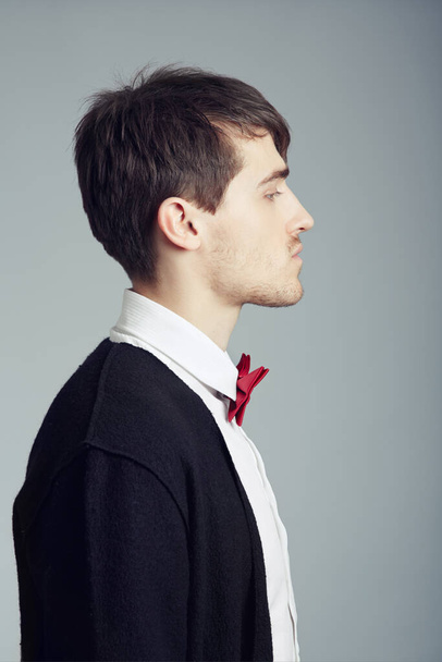 Profile, business and fashion with man, thinking and confident guy on grey studio background. Person, entrepreneur or model with stylish outfit, elegant clothes or worker with professional or bow tie. - Fotó, kép