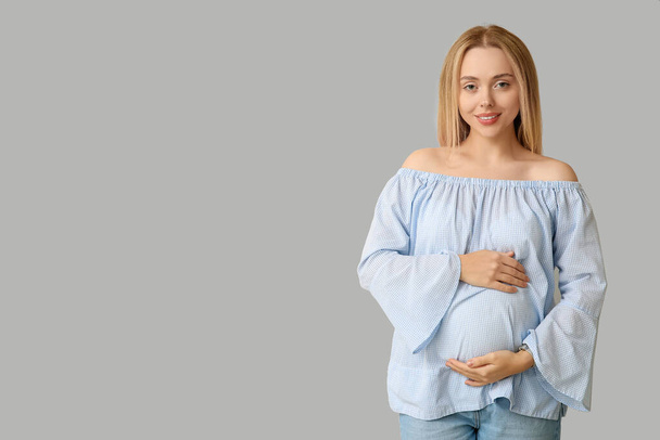 Happy pregnant woman on light background - Photo, Image