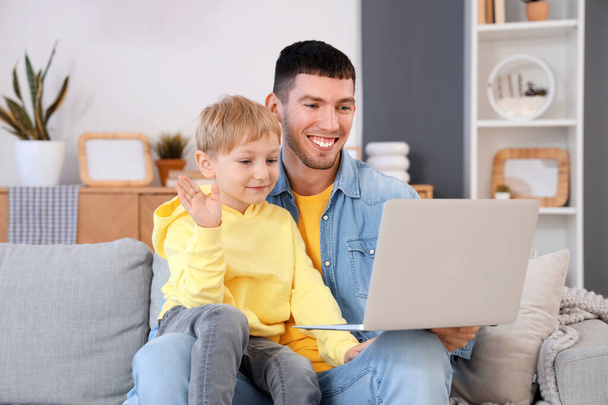 Little boy with his father video chatting at home - Photo, Image