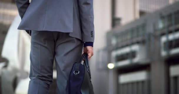 Legs, bag and back of business man walking, travel and on morning commute to law firm, office building or workplace. Lawyer briefcase, expert businessman and male attorney on outdoor city trip. - Footage, Video