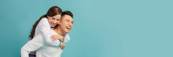 Happy smiling couple in love. Over blue background - Photo, Image