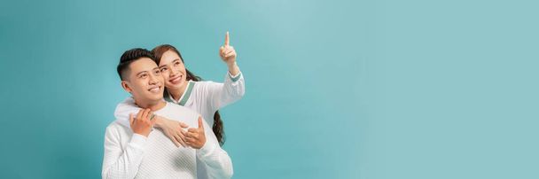 Attractive woman is indicating direction and pointing with index finger the way - Photo, Image