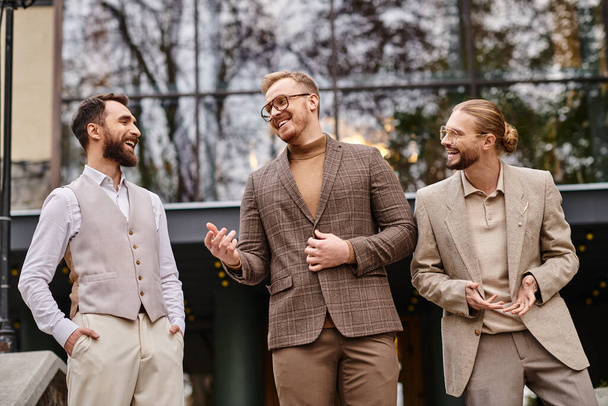 jolly handsome business leaders with glasses in fashionable attires discussing their startup - 写真・画像