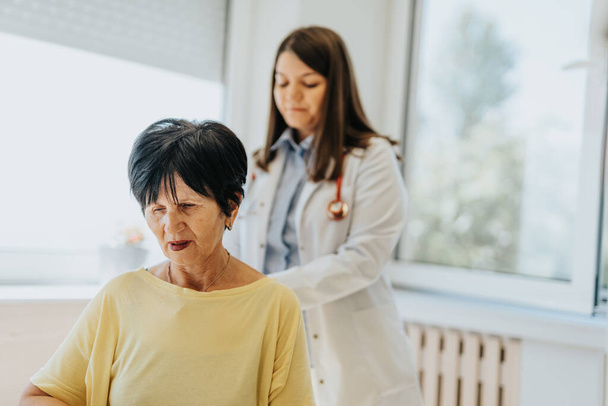 A caring and experienced doctor provides medical advice and diagnosis to a patient during a clinic visit. Test results are discussed, and treatment options are explained. - Photo, Image