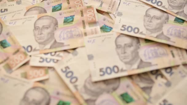Regulacja ostrości na ukraińskich banknotach 500 hrywien. Wideo skupiające się na ukraińskim rachunku pieniężnym na stole - Materiał filmowy, wideo