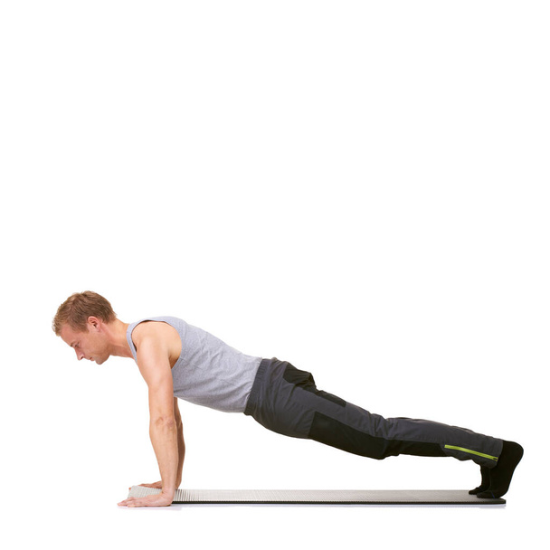 Man, workout and mat in studio for push ups, fitness or exercise for healthy body, wellness or core muscle. Person, balance and training on floor or abdomen health on mockup space or white background. - Photo, Image