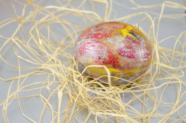 Рука намалювала великоднє яйце на соломі
 - Фото, зображення