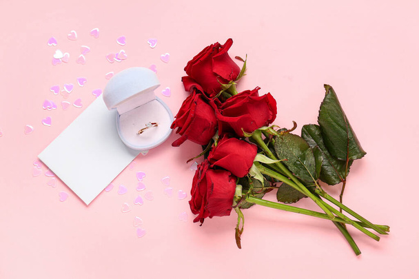 Hermosa composición con anillo de compromiso y flores de color rosa sobre fondo rosa. Celebración de San Valentín - Foto, Imagen