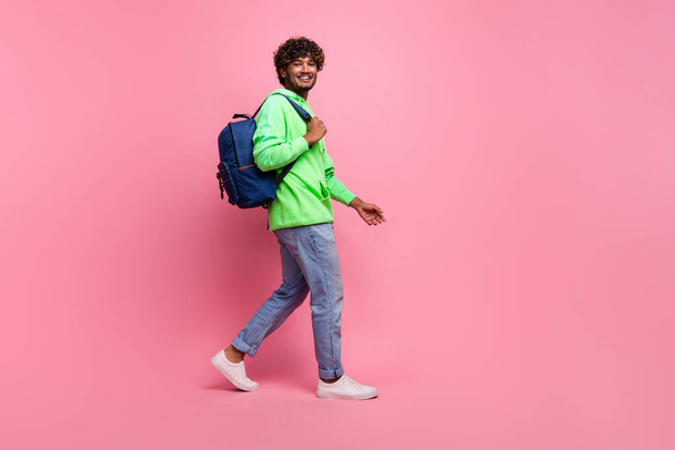Full body length photo of steps young hipster student indian man wear rucksack behind going to study isolated on pink color background. - 写真・画像