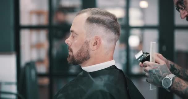 Hair care, cut and man in barbershop with clipper, comb and tools for trendy haircut at small business. Style, barber and client in chair for grooming service, creative hairstyle or professional trim. - Footage, Video
