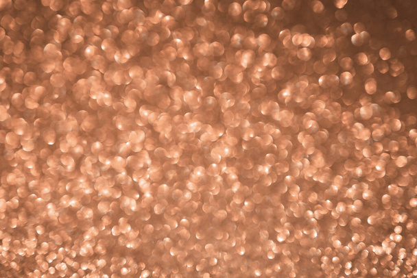 Peach fuzz sparkling glitter bokeh background, abstract defocused texture. Holiday lights. Color of the year 2024 - Photo, Image