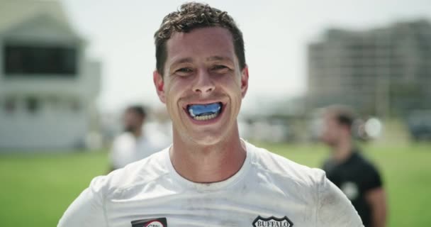 Sports, mouth guard and portrait of man with smile on field for game, competition or exercise at club. Confidence, pride and face of happy, professional rugby player at stadium for fitness or workout. - Footage, Video