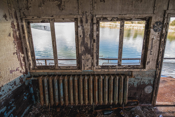 Interior of old floating restaurant in Pripyat ghost city in Chernobyl Exclusion Zone in Ukraine - Photo, Image