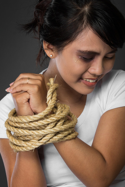 woman with hands tied up with rope being abused - Fotoğraf, Görsel