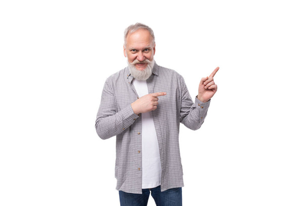 handsome funny gray-haired elderly man with a beard and mustache in a plaid shirt on a white background with copy space. - Photo, Image