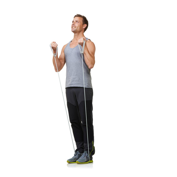 Stretching, man and resistance band to workout in studio, gym and bicep training to strong or muscle sculpt. Sports person, smile and exercise for commitment in mockup and fitness on white background. - Photo, Image