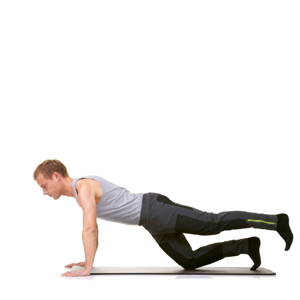 Man, pilates and mat in studio for stretching legs, fitness or workout for healthy body, wellness or core muscle. Person, exercise or yoga on floor for abdomen on mockup space or white background. - Photo, Image