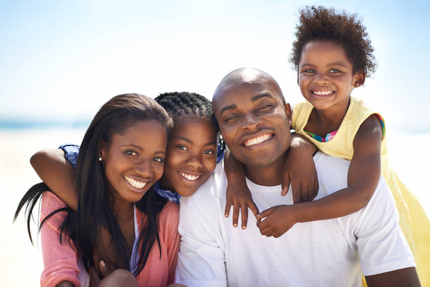 Černá rodina, rodiče a děti s objetím na pláži pro dobrodružství, dovolenou nebo dovolenou v létě. Afričané, tvář a úsměv venkovní v přírodě pro objetí, zkušenosti nebo sblížení a vztah. - Fotografie, Obrázek