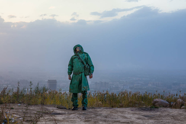 man in a gas mask in a polluted city - Photo, Image