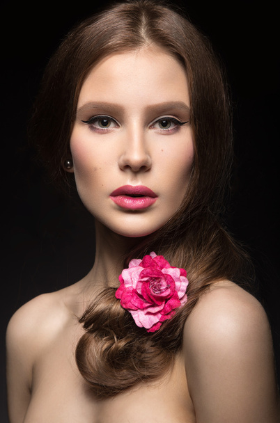 Beautiful girl with pink lips and a rose in her hair.  Beauty face. - Foto, Imagem