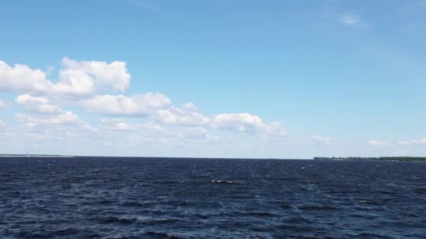 Η τέλεια επιφάνεια της θάλασσας κάτω από ένα φωτεινό γαλάζιο ουρανό με σύννεφα - Πλάνα, βίντεο