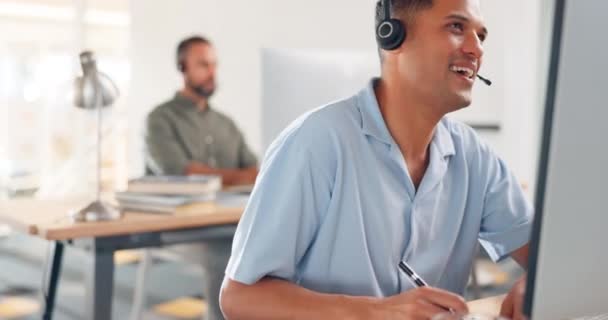 Man, consultant and call center writing notes in telemarketing for customer support or advice at the office. Male consulting agent in contact us with headset on computer for online assistance or help. - Footage, Video