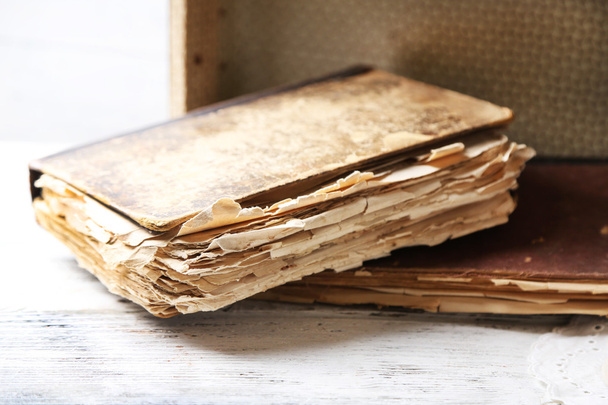 Old wooden suitcase with old books on wooden background - Foto, Imagem