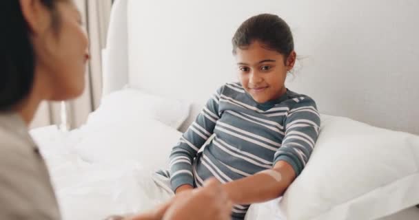 First aid, high five and bandage with mother and daughter in bed for motivation, wellness and help or support. Love and accident with happy child and parent in family home for injury and healthcare. - Footage, Video