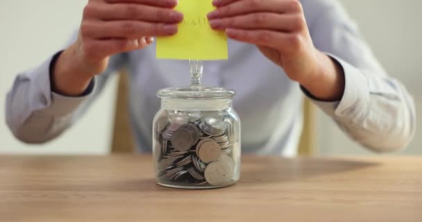 Transparent piggy bank with coins and a sticker with text education. Save for children education and paid tuition - Footage, Video