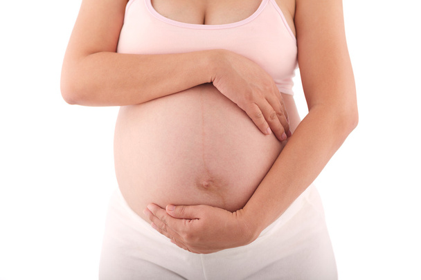 Kobieta w ciąży z jej ręce na brzuch - Zdjęcie, obraz