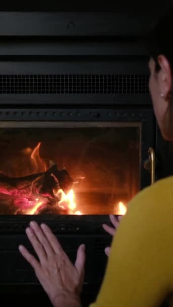 woman warming hands near  fireplace - Footage, Video