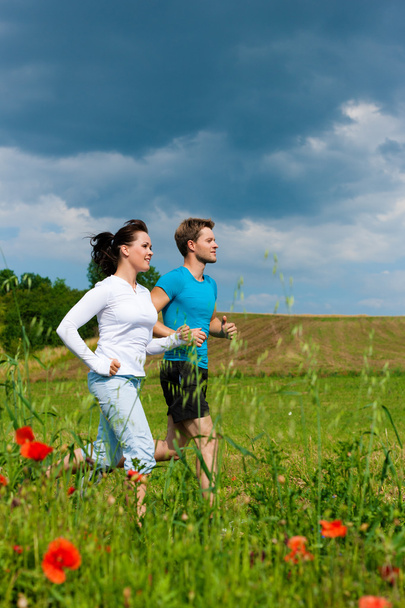 Young sportive couple is jogging outside - Fotografie, Obrázek