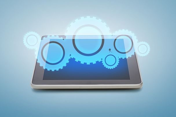 tablet pc with cogwheel icon over screen - Foto, Imagen