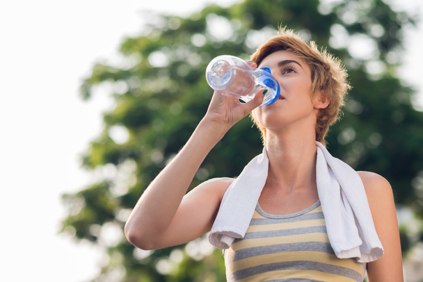 Frau trinkt Wasser nach dem Training - Foto, Bild